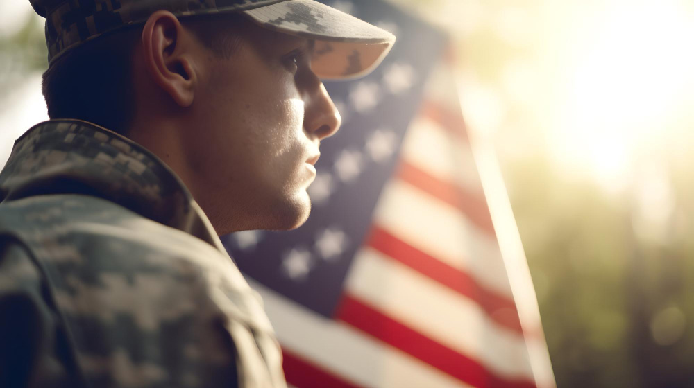 Soldier Thinking In Front Of Flag - What's the Big Deal About Veterans - Article By Be Pain Free Global
